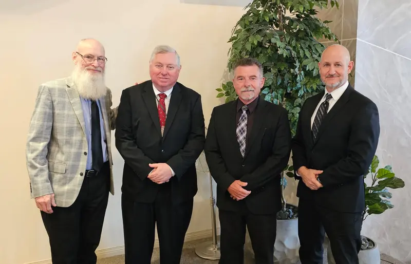 Four conference speakers standing together before a session