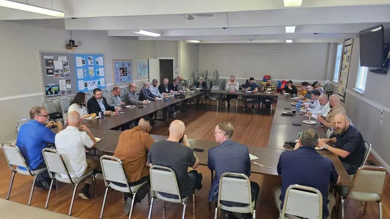 Pastors seated around a large table for a roundtable discussion